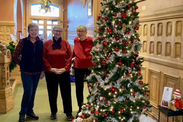 Assistance League members with their newly decorated tree