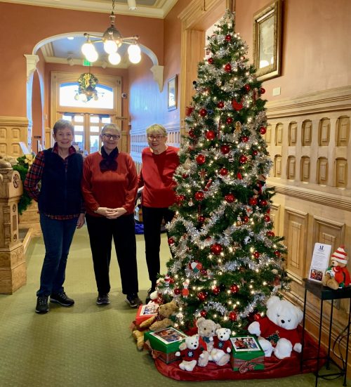 Assistance League members with their newly decorated tree