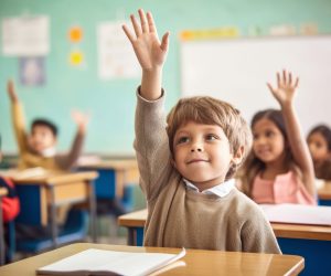 photo of Boy holding hand up in class