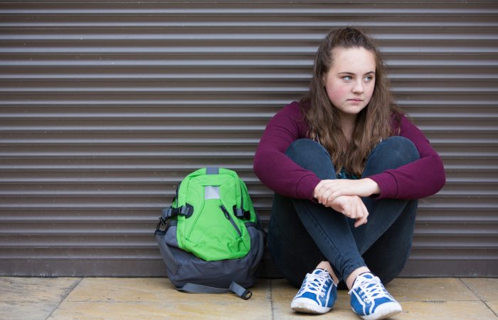 Homeless teen with backpack